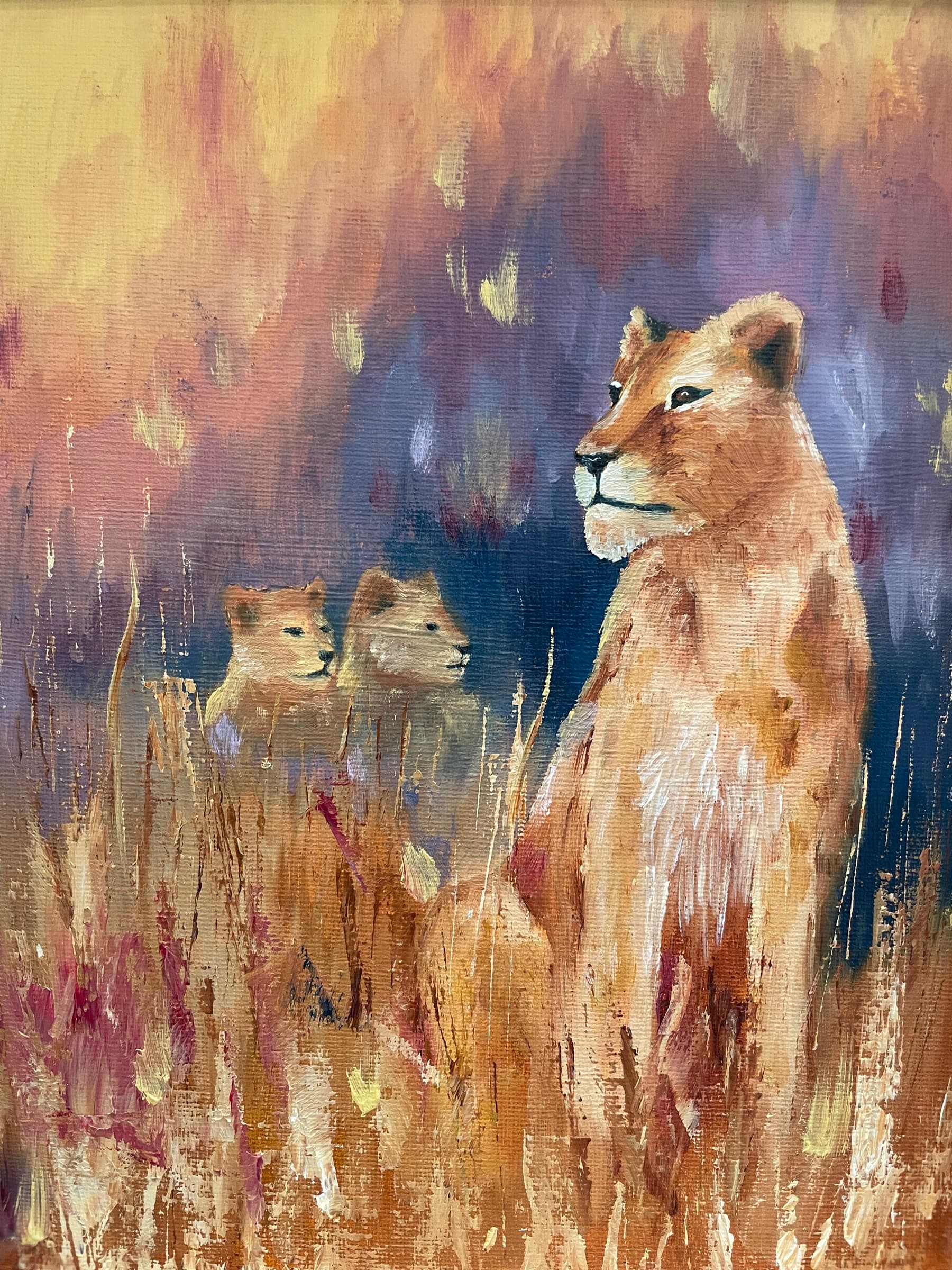 Oil painting of a lioness sitting upright in tall golden grass, two cubs behind her, under a violet and amber sky
